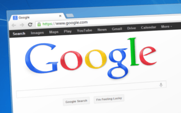 s screenshot of the Google search engine in front of a blue background