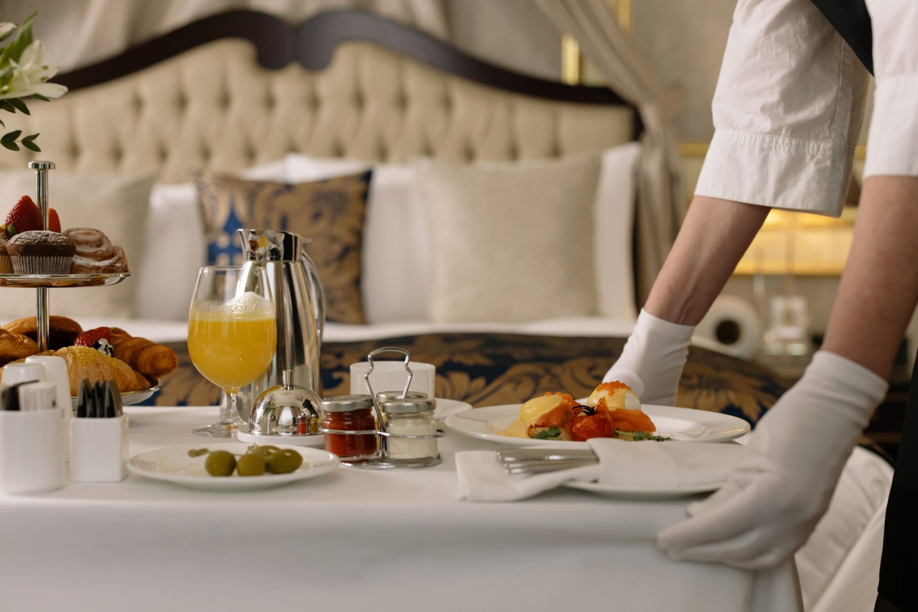 person serving breakfast in a hotel room