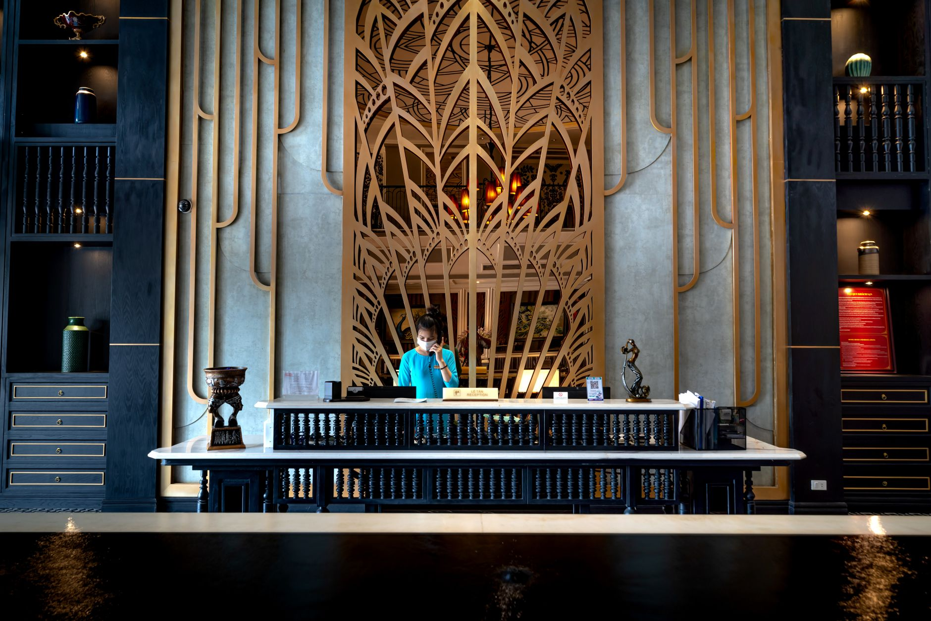 woman behind the desk at the reception in a luxurious hotel